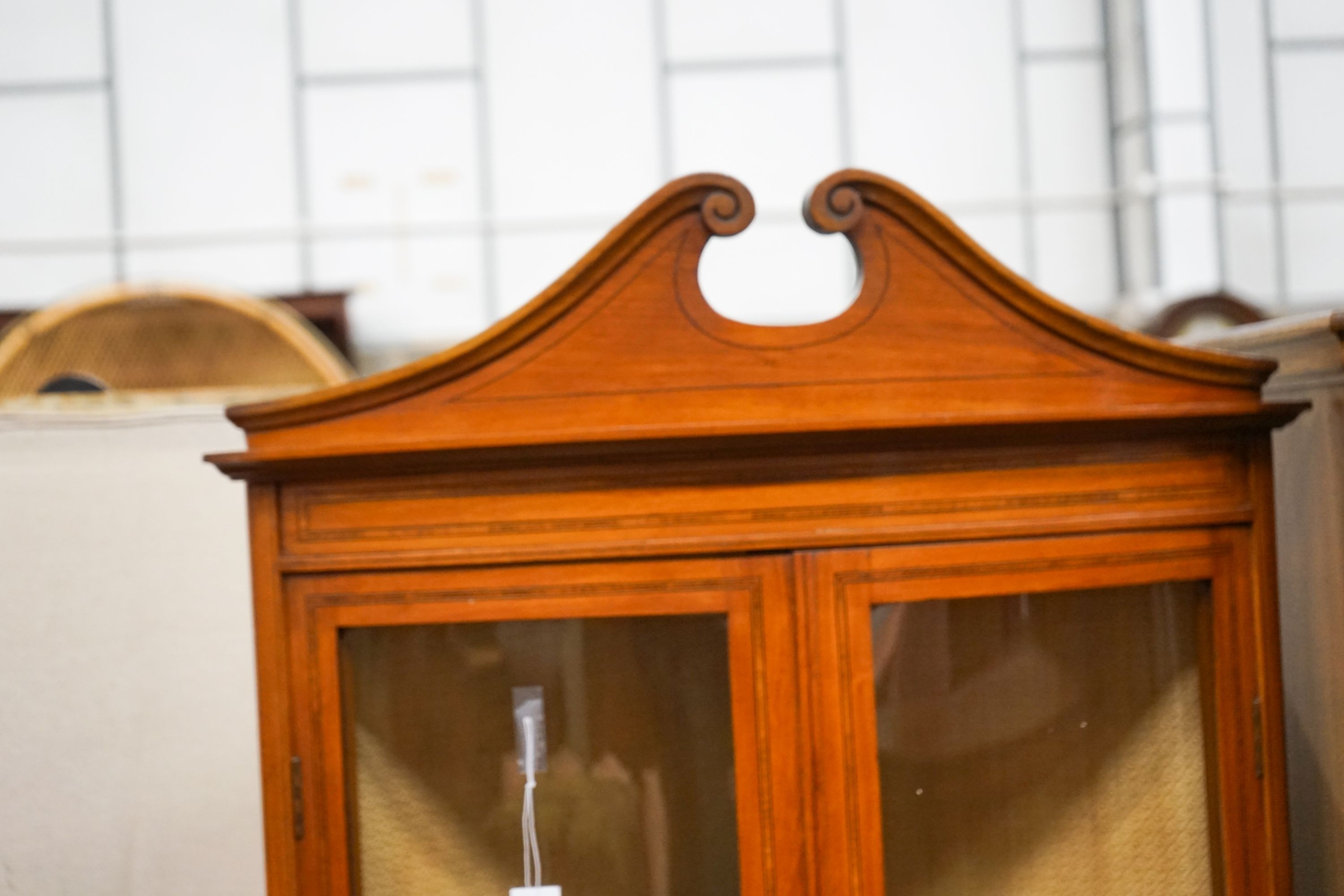 An Edwardian banded satinwood bowfront standing corner cabinet, width 76cm, depth 41cm, height 190cm